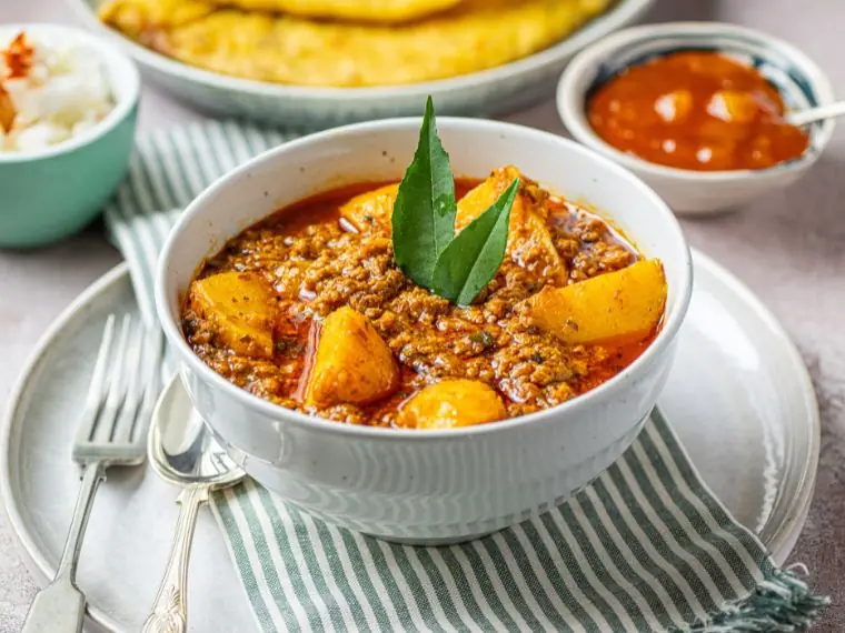 Authentic lamb keema aloo curry with spiced minced lamb and potatoes garnished with curry leaves | Alvi's Homemade